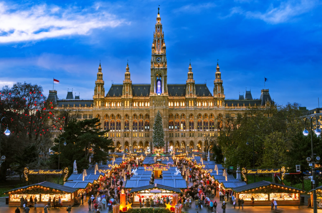 Beautiful Christmas Market in Europe with festive lights, Christmas tree and wooden stalls during winter.